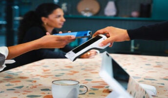 Person performing a mobile payment on a card terminal. Source: Tech.co