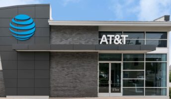 AT&T corporate office with logo on a partly cloudy day