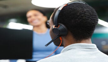 Back of man's head, wearing a headset. Source: Tech.co