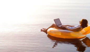 Woman works from the comfort of an inflatable lilo