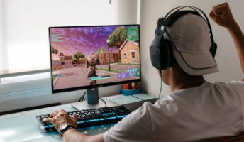 Young person plays popular Epic Games title Fortnite on PC computer