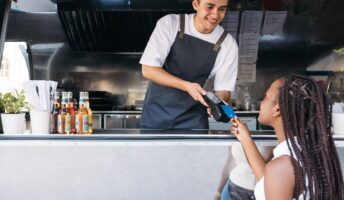 food truck vendor taking a payment on a POS system