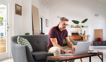 Man working remotely on his sofa