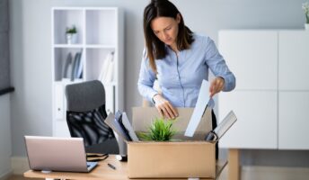 Women is packing up her stuff after quitting