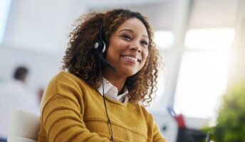 Happy worker using a VoIP phone system