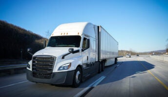 White truck driving on a highway