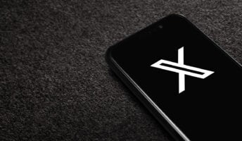 Phone with X logo on black background