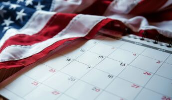 US flag over a calendar