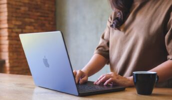 A person works remotely using an Apple laptop.