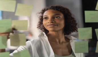 woman working on kanban board with post its