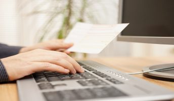 man using computer to pay for an invoice