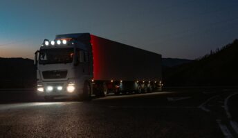 A truck drives at night