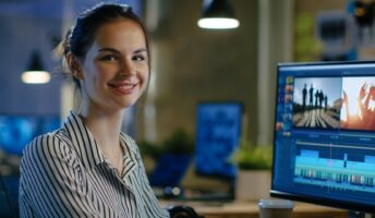 woman sat at desk editing video