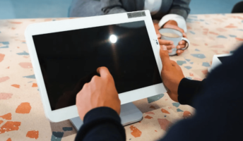 A person uses a POS system in a cafe. Image: Tech.co