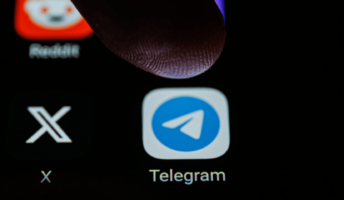 A person pressing the telegram app on their phone.